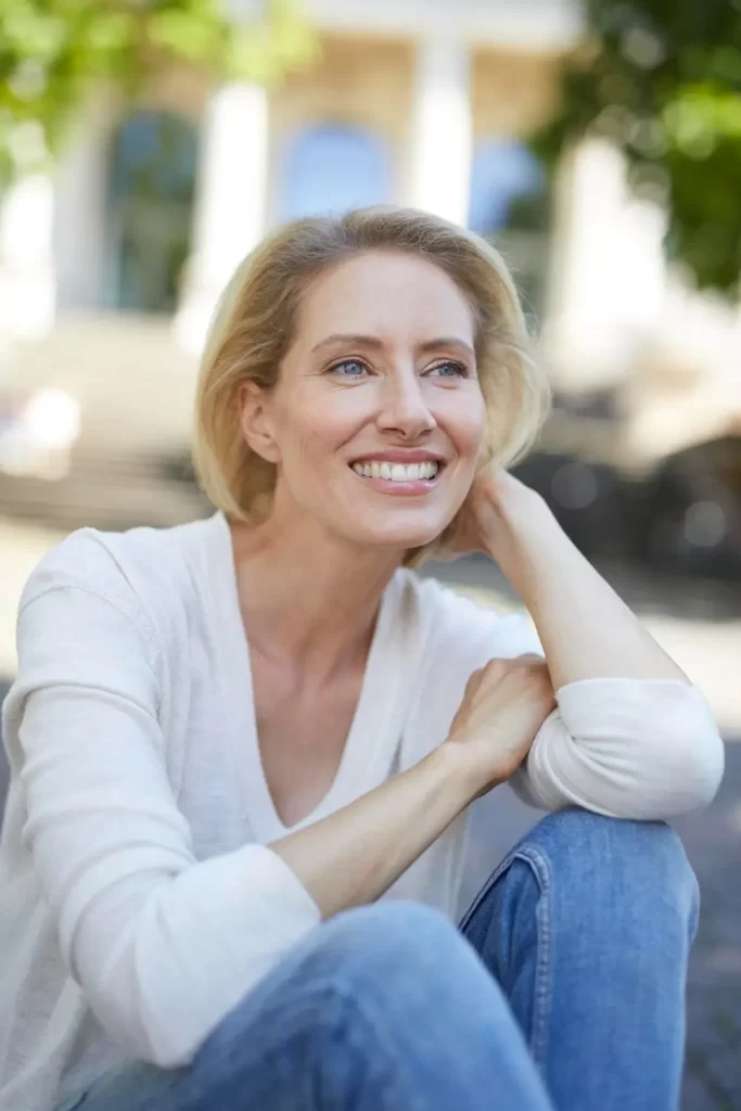 Portrait of smiling blonde woman outdoors